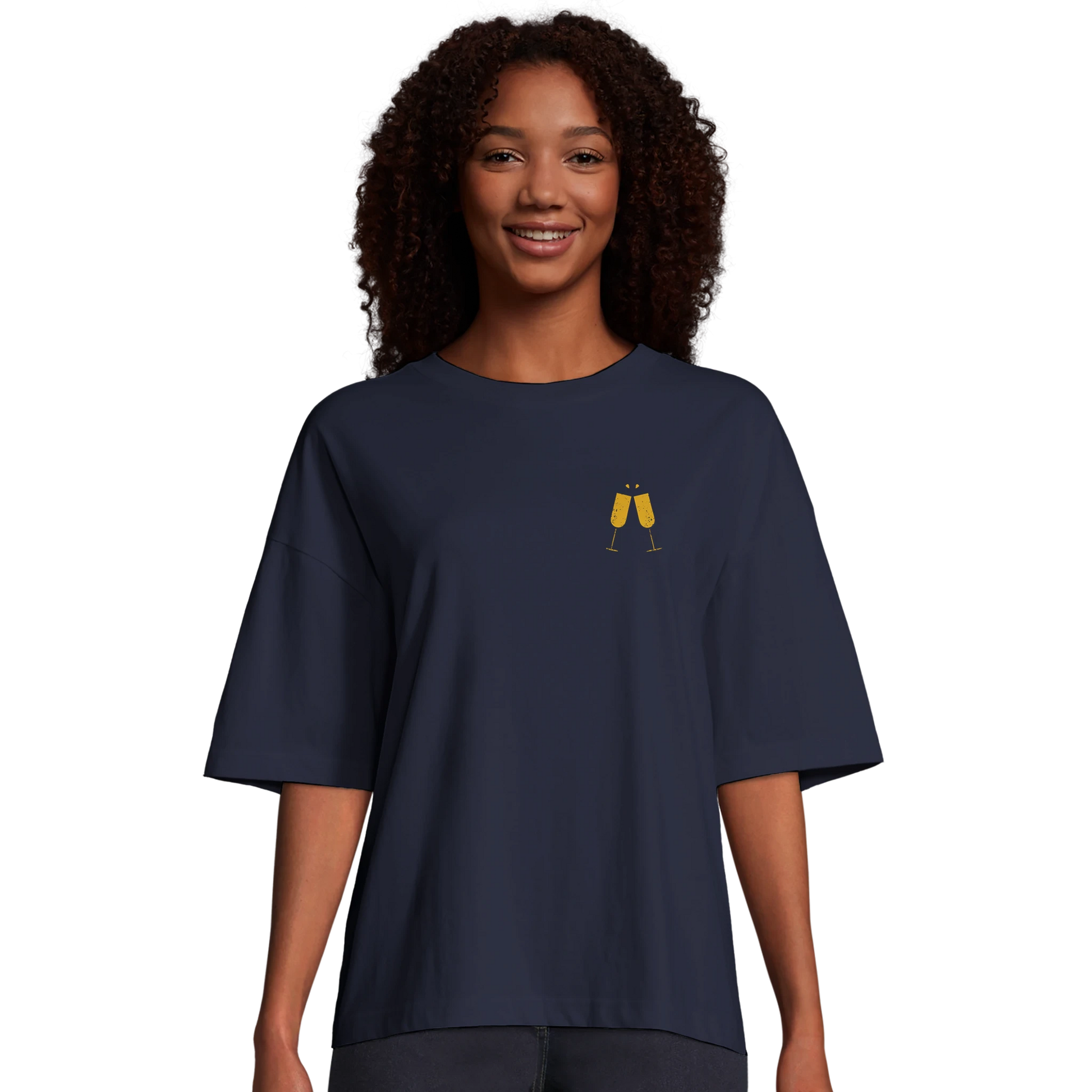 Kvinna bär marinblå oversized t-shirt med champagne-motiv. Modellen visar den boxiga passformen och korta ärmar.