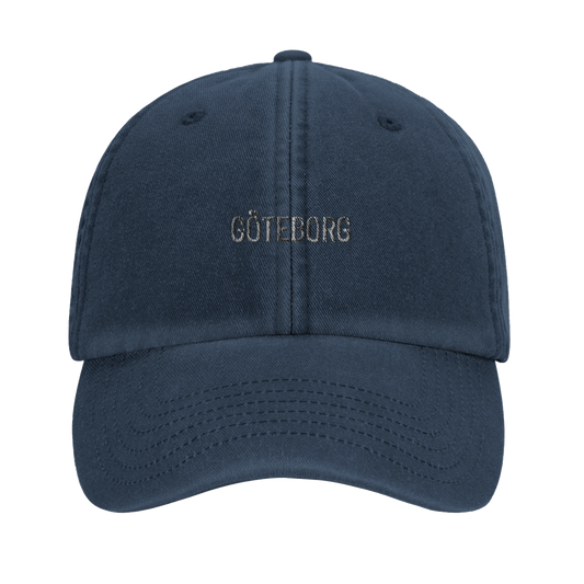 Marinblå pappakeps i vintagestil med broderad text 'GÖTEBORG'. En klassisk dad hat med sliten look för en tidlös Göteborgs-stil.
