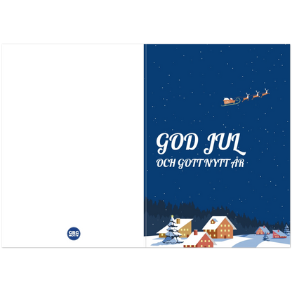 Vykort A6 med snötäckt by och upplysta hus en julnatt, God Jul-hälsning i vitt
