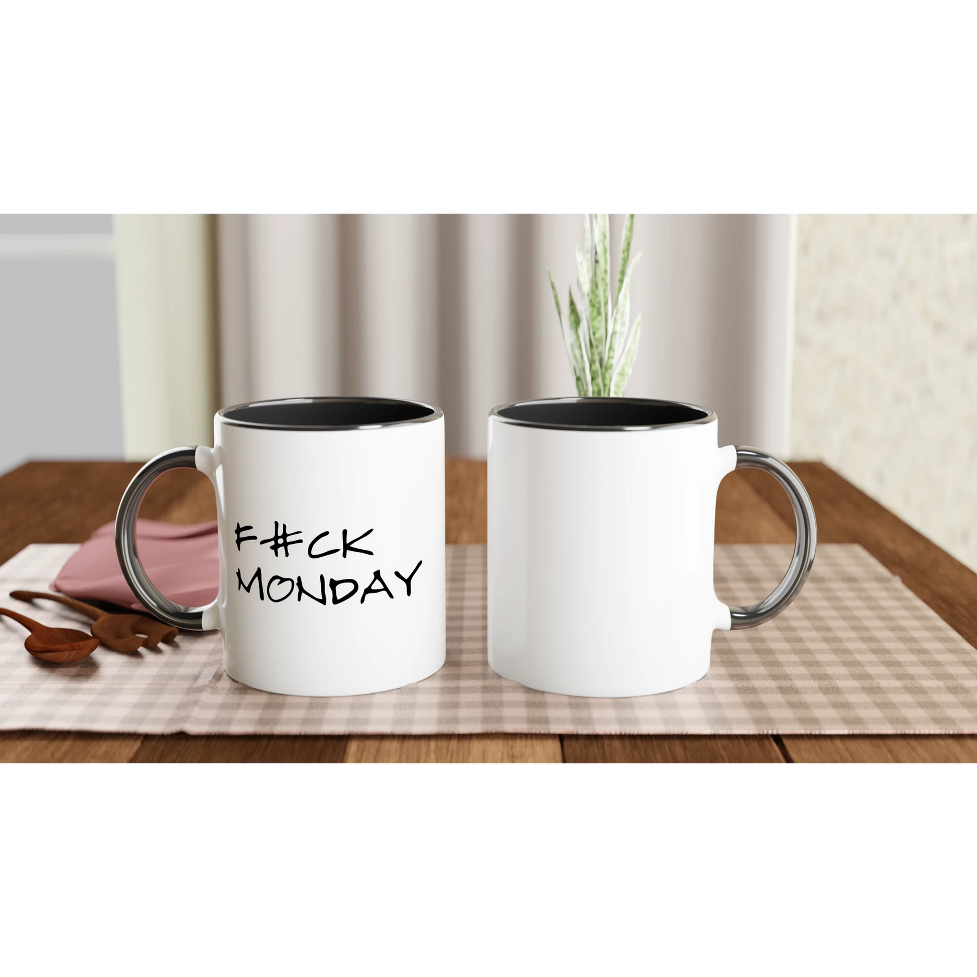 En 'F#CK MONDAY' mugg med svart insida placerad på en duk. Visar muggens storlek och stil i en naturlig miljö för kaffepausen.